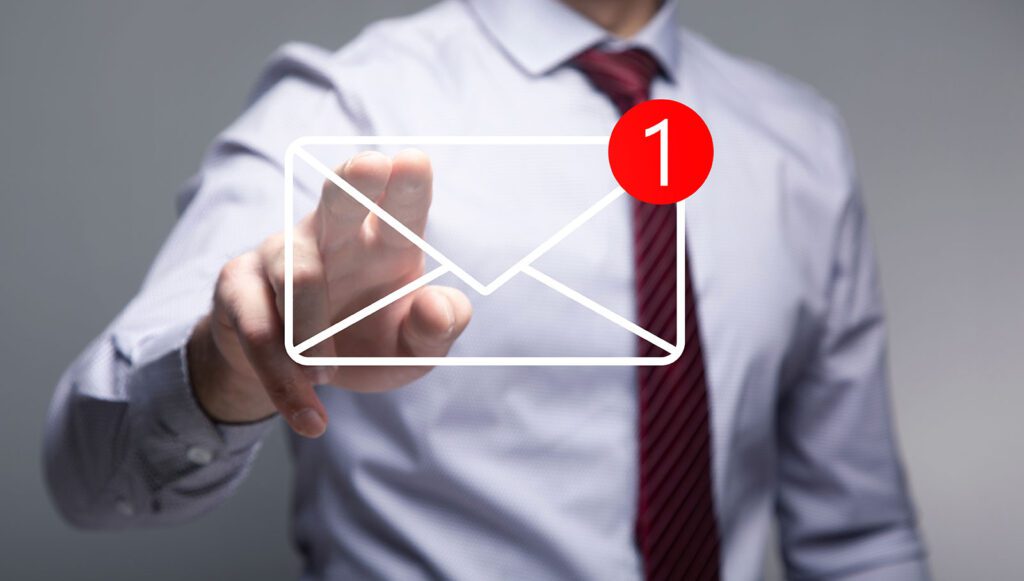 Businessman checking a new email notification on a virtual screen.