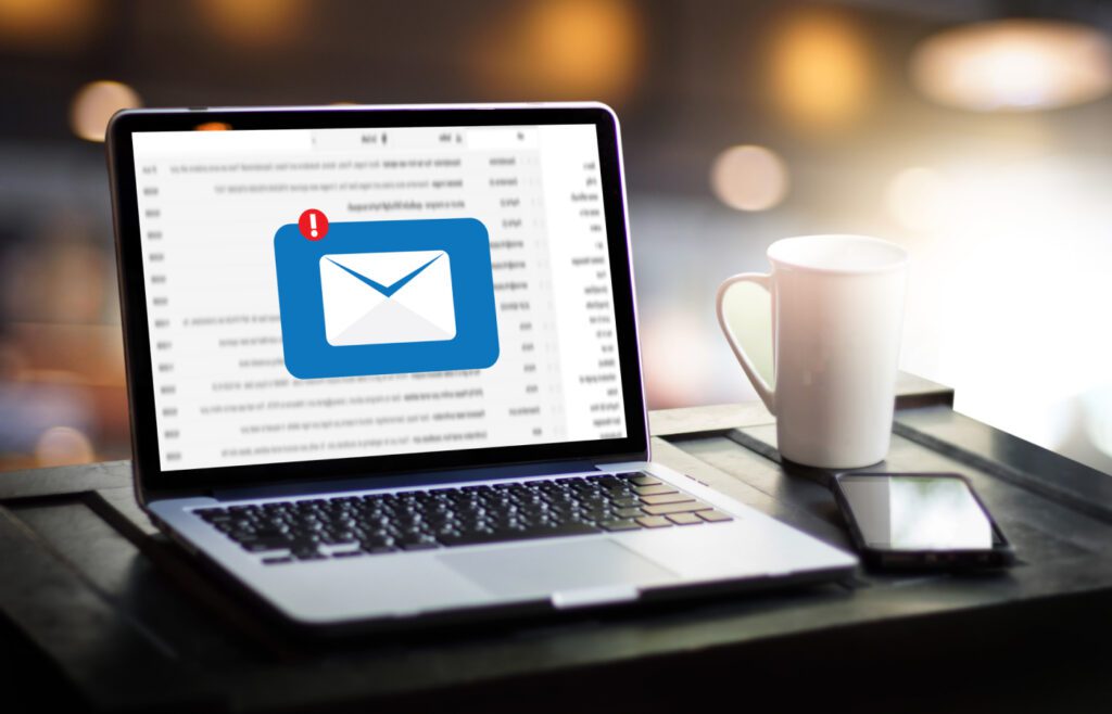 Laptop screen showing an email notification with a coffee cup nearby.