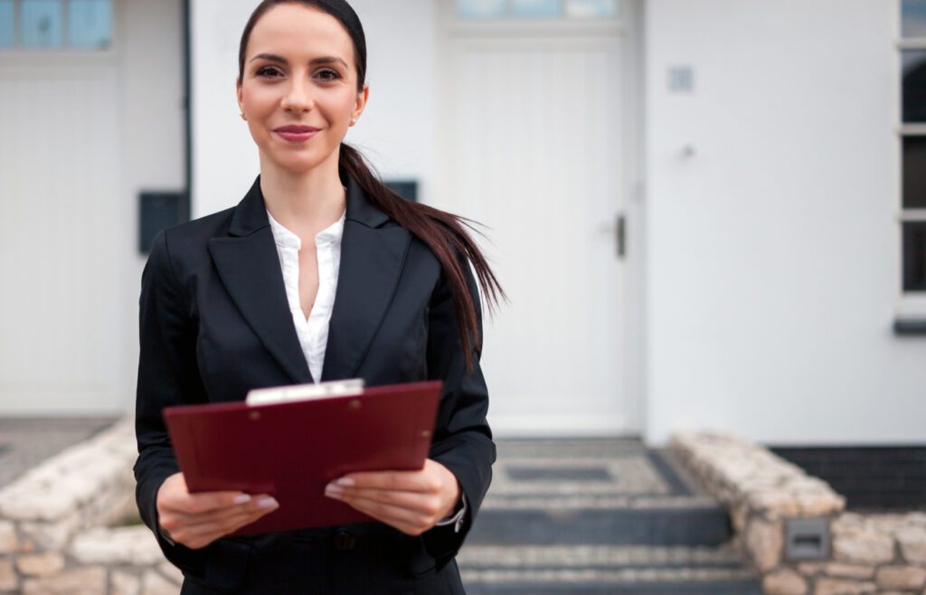 Confident female professional holding a clipboard outdoors.