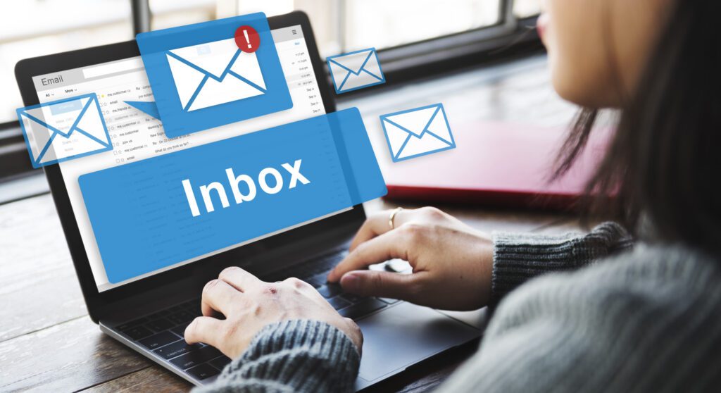 Person checking a crowded email inbox on a laptop.