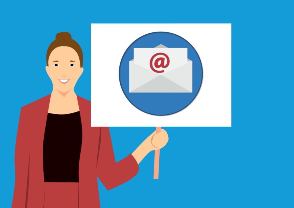 Woman holding sign with email envelope icon.