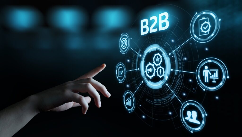 Hand interacting with futuristic B2B digital interface icons.
