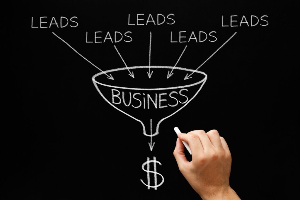 Hand drawing a business funnel converting leads into revenue.