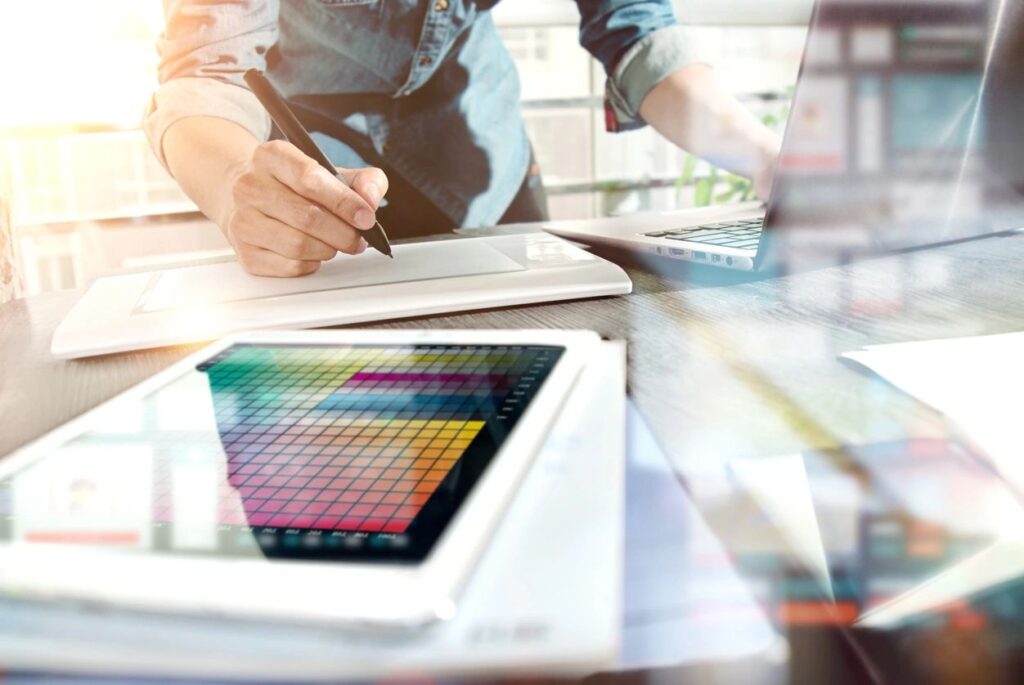 Person working on a digital tablet with color palette and stylus.