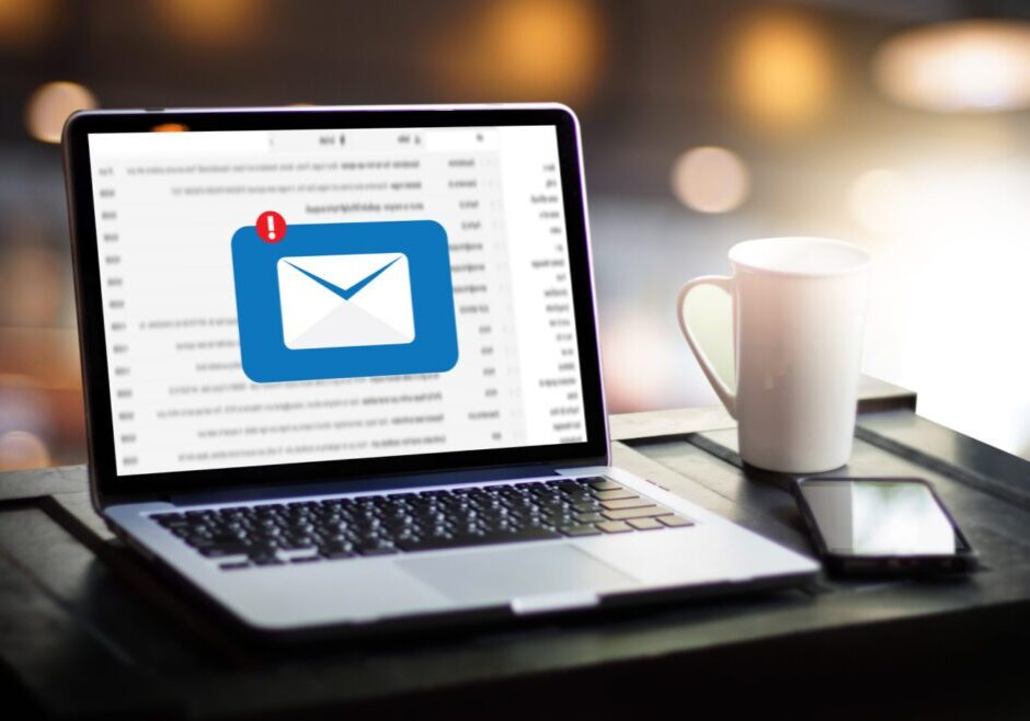 Laptop screen showing an email notification with a coffee cup nearby.