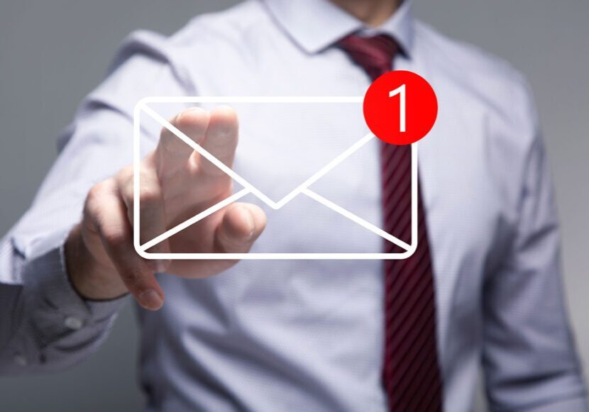 Businessman checking a new email notification on a virtual screen.
